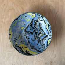 Load image into Gallery viewer, Top view of a round ceramic bowl with blue and yellow marbled pattern on a wooden surface
