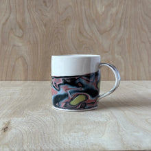 Load image into Gallery viewer, Porcelain mug with marbled design on a wooden surface
