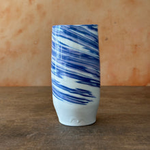 Load image into Gallery viewer, Ceramic vase with blue and white marbled pattern on a wooden surface
