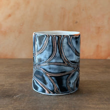 Load image into Gallery viewer, Ceramic mug with textured design on a wooden surface
