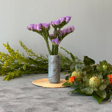 Load image into Gallery viewer, Marbled gray vase with purple flowers surrounded by additional flowers on a neutral base.

