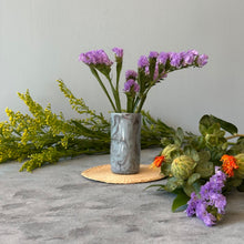Load image into Gallery viewer, Marbled gray vase with purple flowers surrounded by additional flowers on a neutral base.
