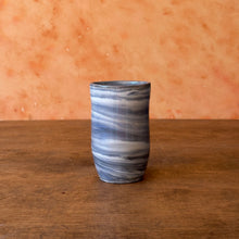 Load image into Gallery viewer, Marbled ceramic vase on a wooden surface with a terracotta wall background
