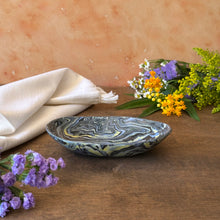 Load image into Gallery viewer, Decorative bowl with marbled pattern on a wooden surface with flowers and a cloth.
