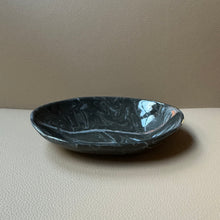 Load image into Gallery viewer, Black ceramic oval bowl on a beige surface with a neutral background
