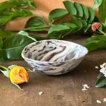 Load image into Gallery viewer, Marble-patterned ceramic bowl on a wooden surface with green leaves and flowers.
